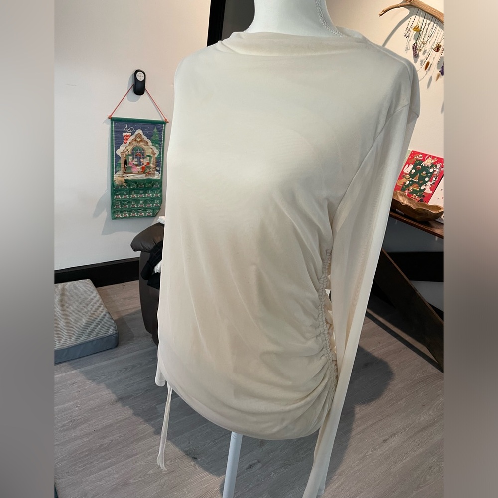 Cream colored blouse with sheer back